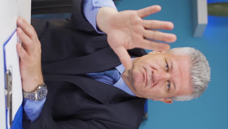 Vertical-video-of-Businessman-saying-stop-to-camera.